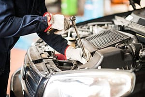 Detail of an auto mechanic at work on a car